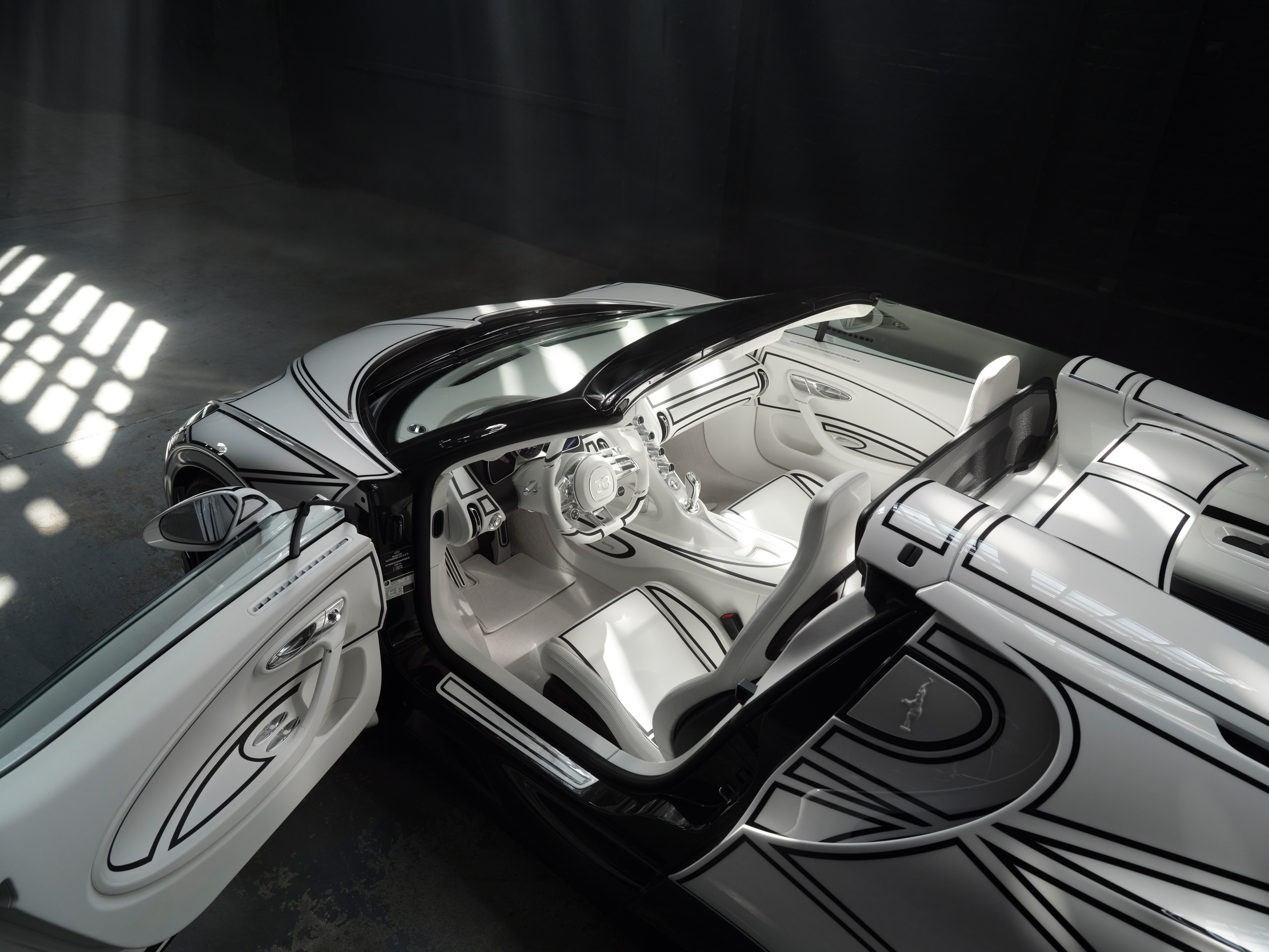 The exterior and interior of this unique W16 Mistral are characterized by delicate, hand-painted black lines and handcrafted porcelain design features.